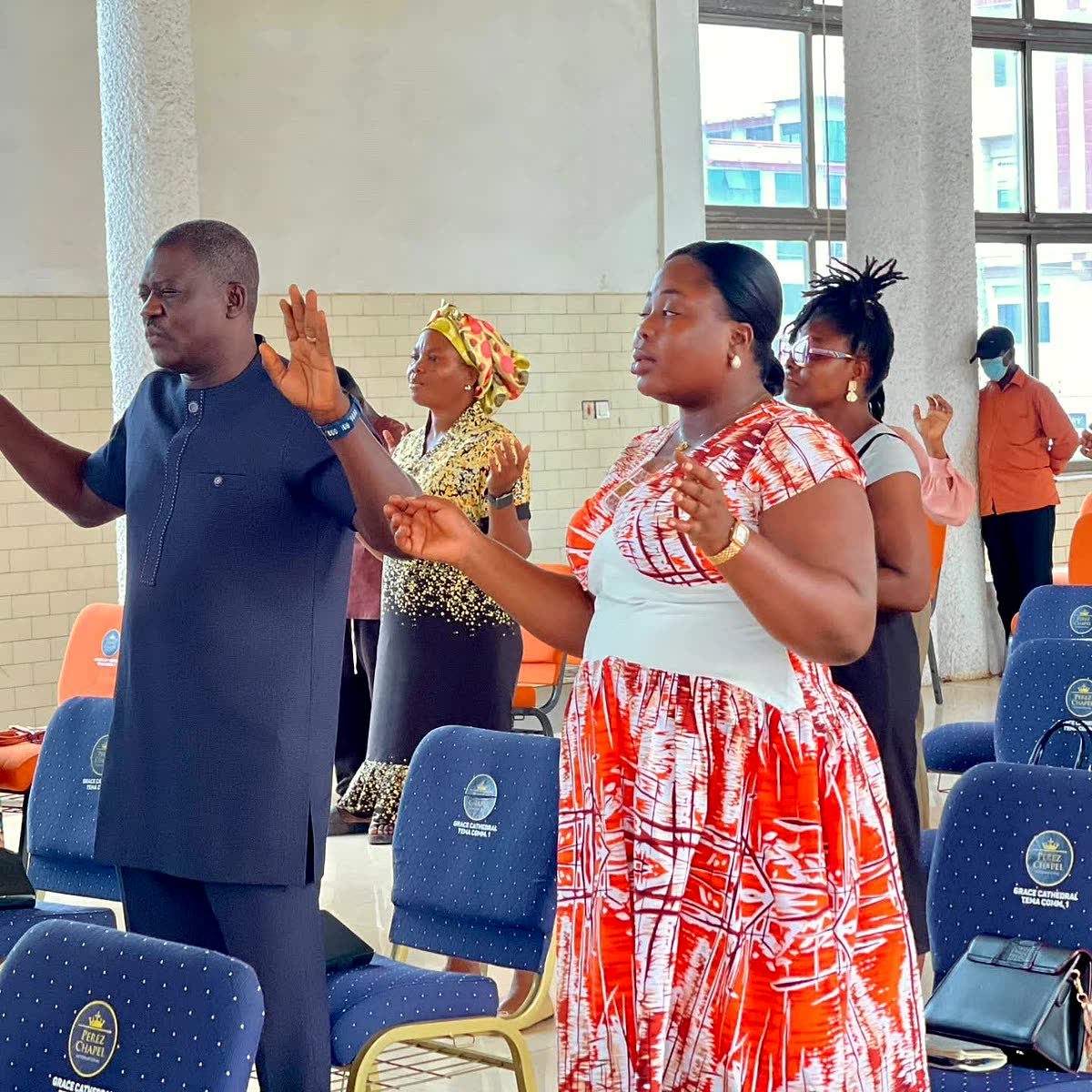 Apostle Lambert praying with a woman in Accra