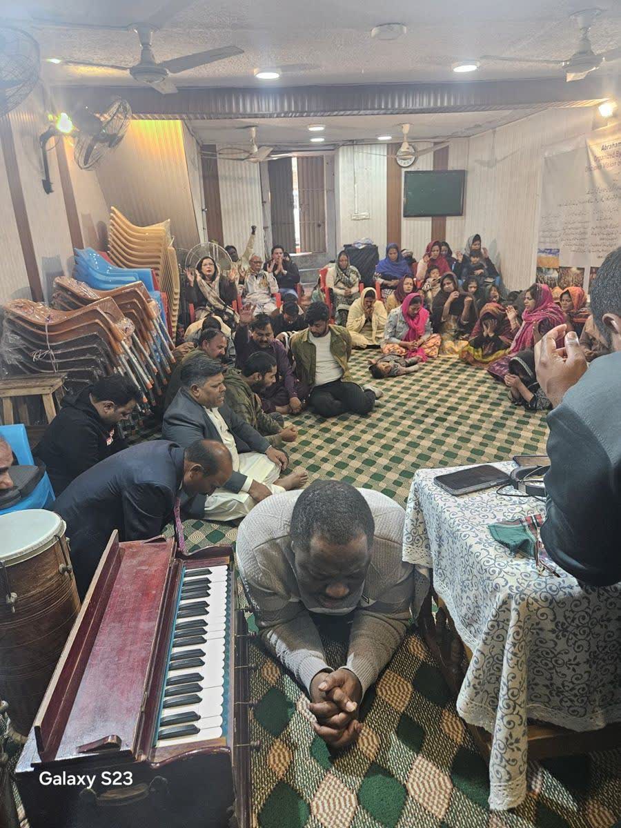 Believers praying at a meeting in Islamabad
